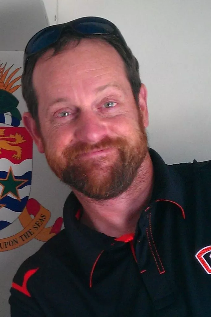 A man with a short red beard smiles at the camera.